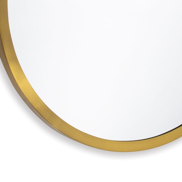 Bottom left corner of a round brass mirror